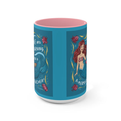 Blue illustrated accent mug with pink interior and mermaid scenes