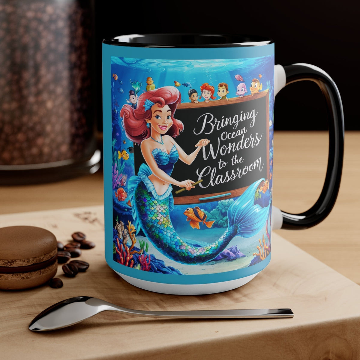 Black ceramic accent mug featuring mermaid and ocean friends, front-left view.