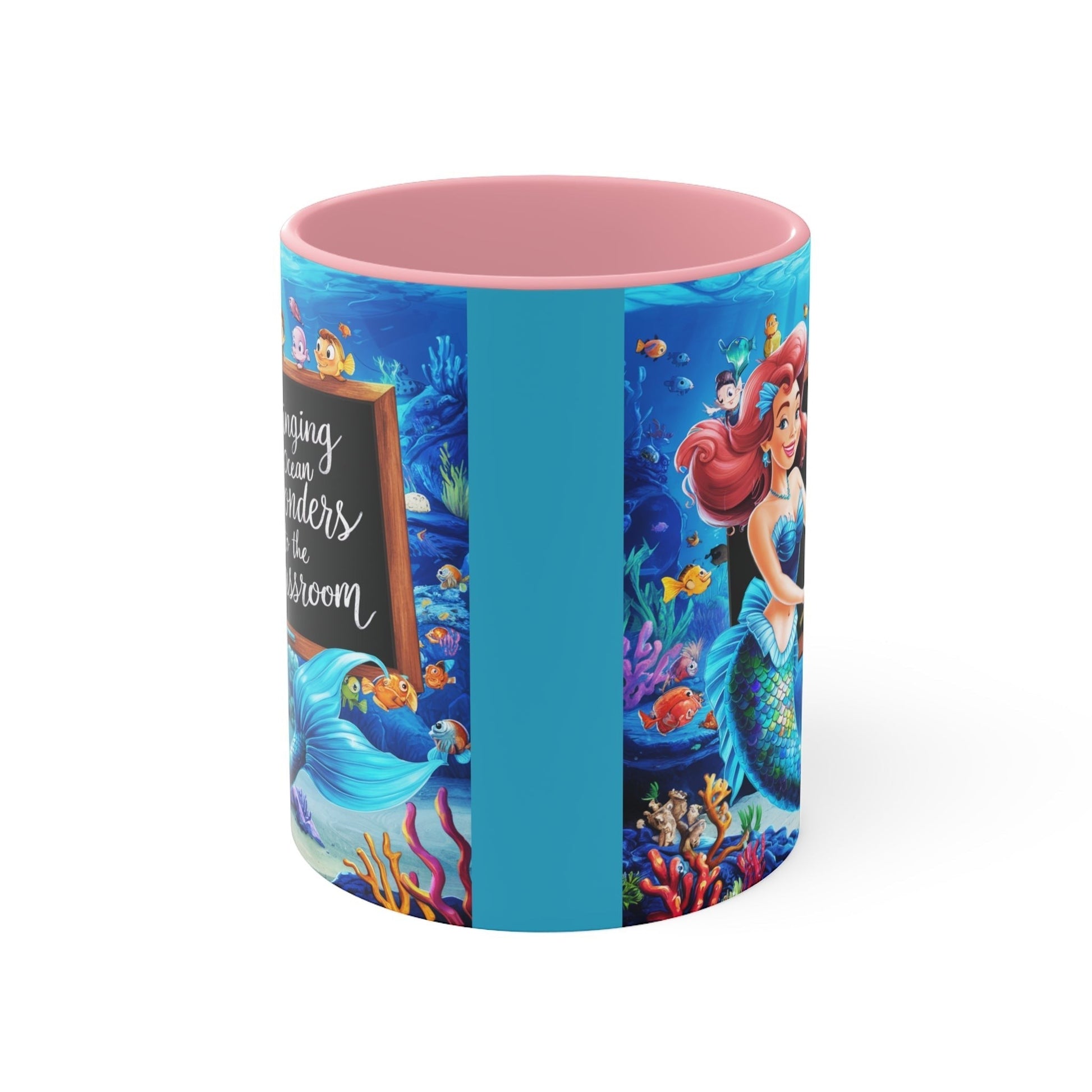 Pink ceramic mug with side panel graphic of underwater characters, pink rim and handle