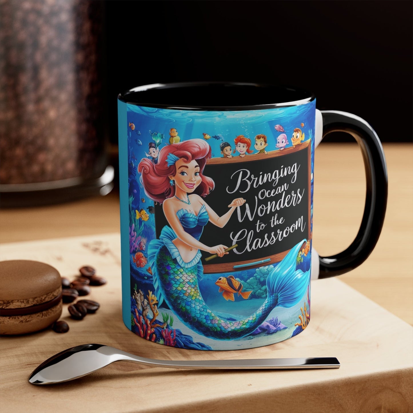 Black ceramic accent mug with mermaid and ocean friends graphic, right-side view.