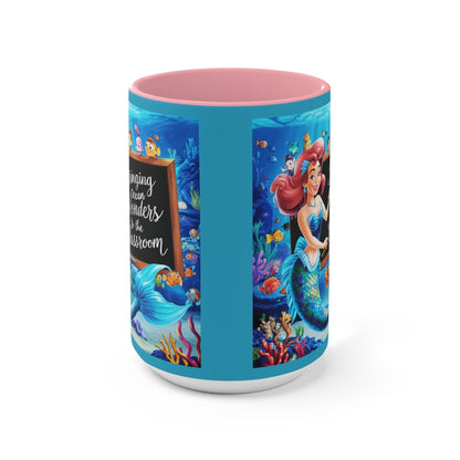 Ocean-themed accent mug with blue sides and pink interior, showing mermaid and ocean scene