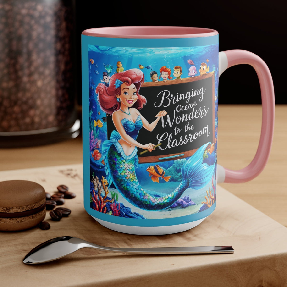 Pink ceramic accent mug with mermaid and ocean friends graphic, side view with handle.