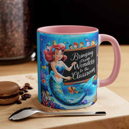 Pink ceramic accent mug with mermaid and ocean friends graphic, handle-on-right view.