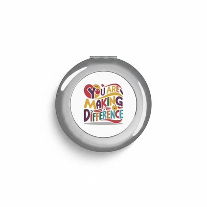Silver glossy compact travel mirror with centered logo graphic on smooth front