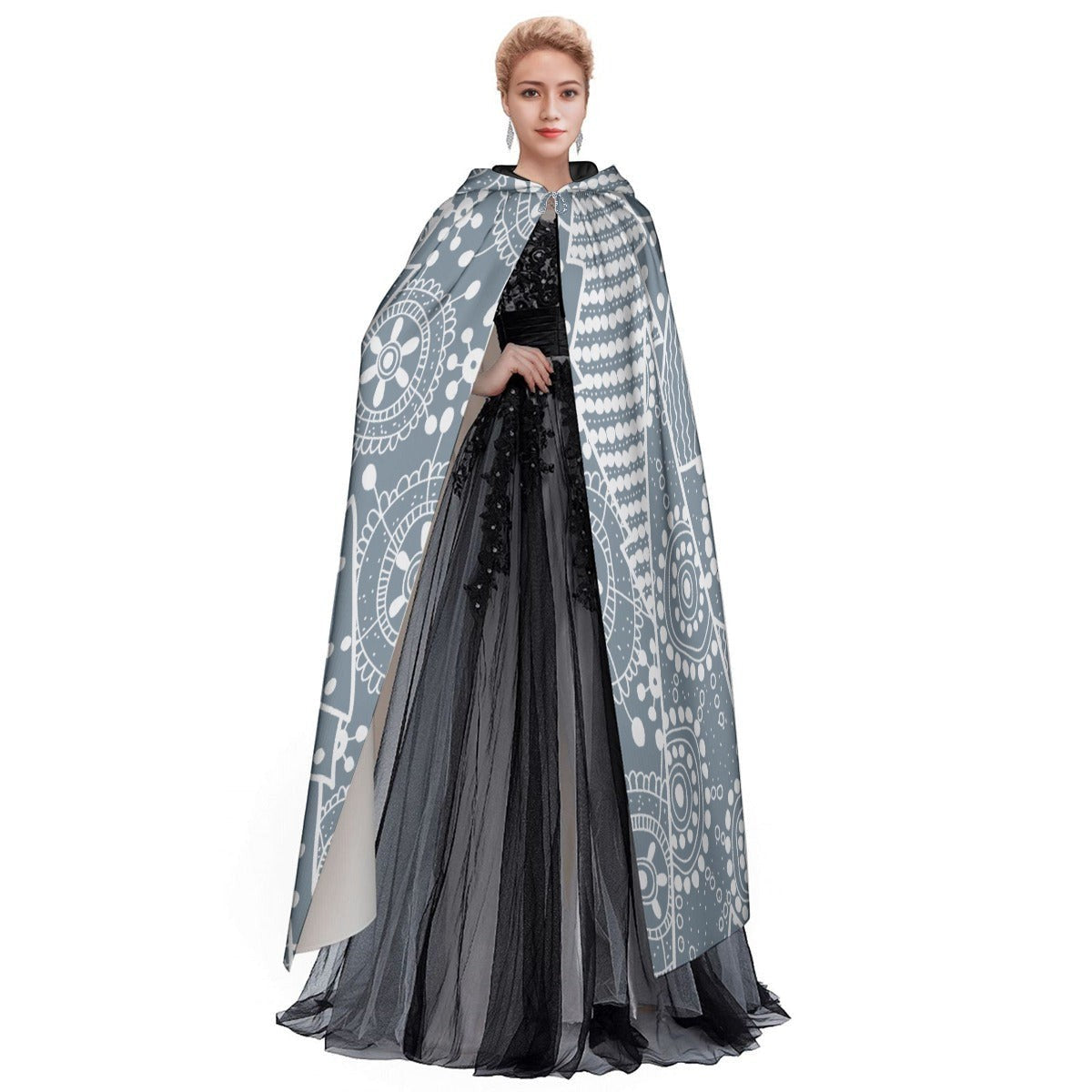 Model wearing hooded cape cloak, blue-gray snowflake print with open front