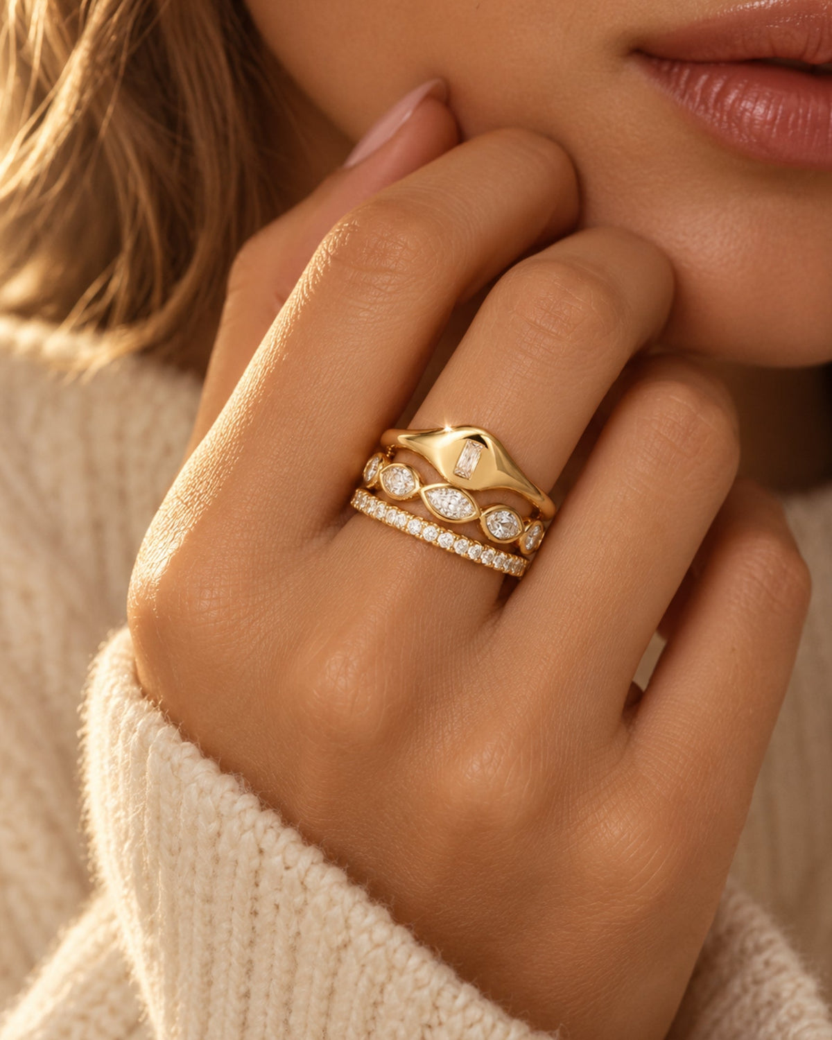 Gold-tone ring set with baguette and round stones in a stacked look