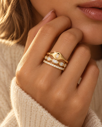 Gold-tone ring set with baguette and round stones in a stacked look