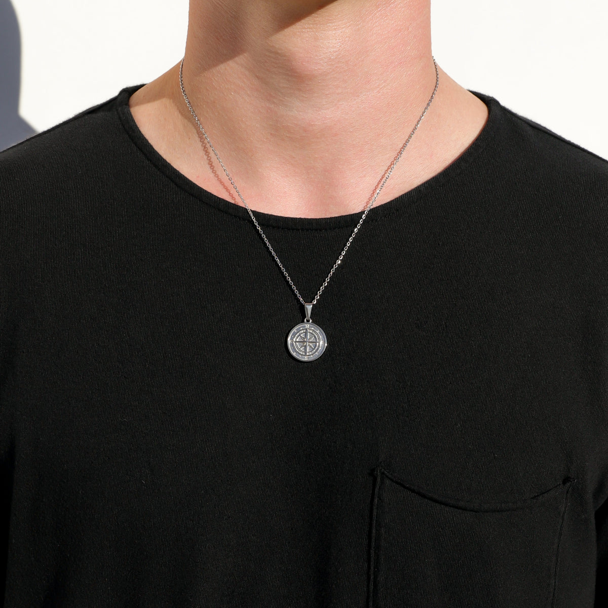 Silver compass pendant necklace set with two stacked round pendants and chain links