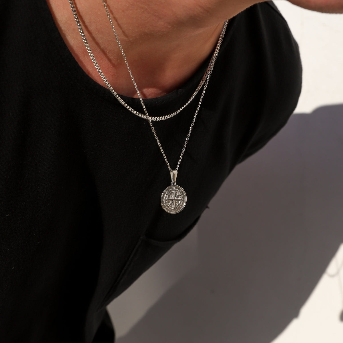 Silver compass pendant necklace set with round compass medallion on a fine chain