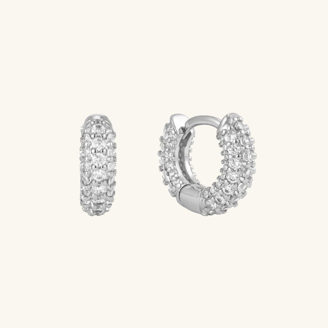 Pavé huggie hoop earrings in silver with clear stones
