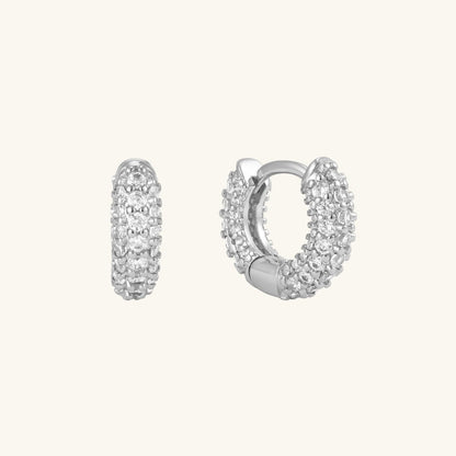 Pavé huggie hoop earrings in silver with clear stones