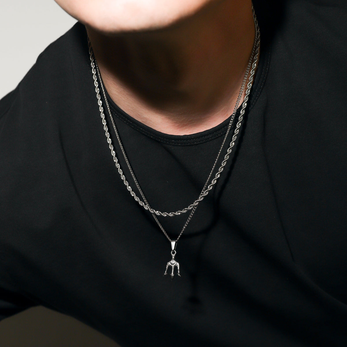 Silver trident pendant necklace with layered chains and center charm