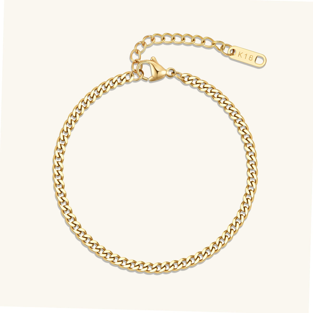 Gold curb chain bracelet with oval clasp tag, polished link chain.