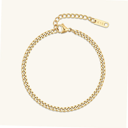 Gold curb chain bracelet with oval clasp tag, polished link chain.