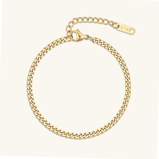 Gold curb chain bracelet with oval clasp tag, polished link chain.