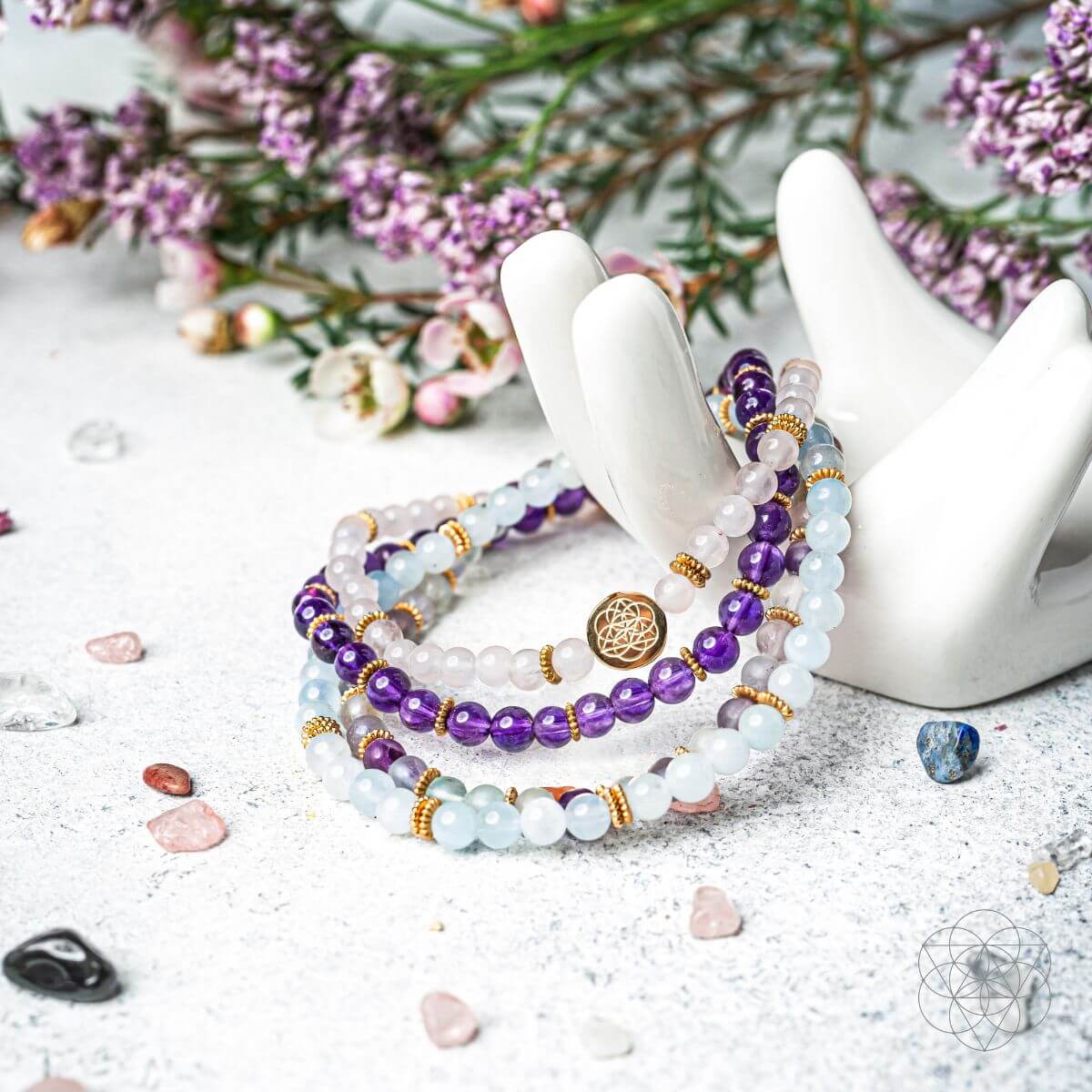 Bracelet set with layered beads and gold accents on a white hand display
