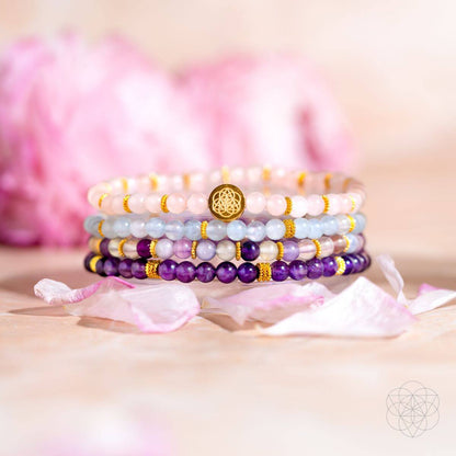 Amethyst, aquamarine, rose quartz, and fluorite beaded bracelet stack with gold accents