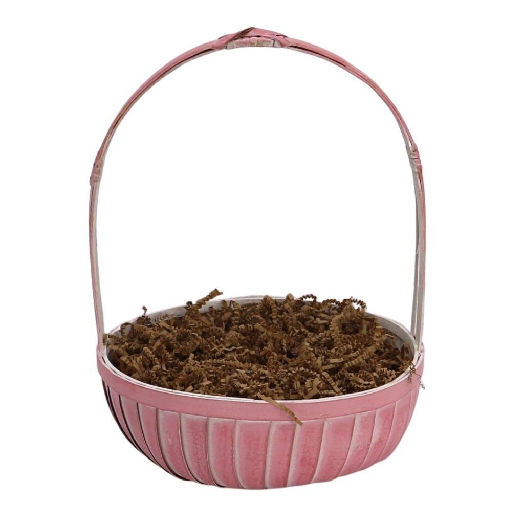 Pink round gift basket with brown shredded filler, no items visible