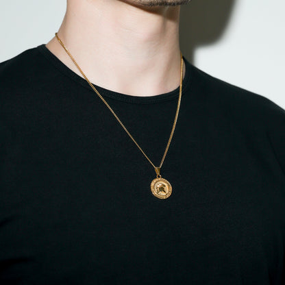 Gold Spartan warrior pendant necklace with round shield-like emblem pendant.