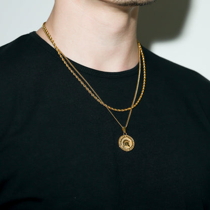 Gold Spartan warrior pendant necklace with round coin pendant hanging on chain.