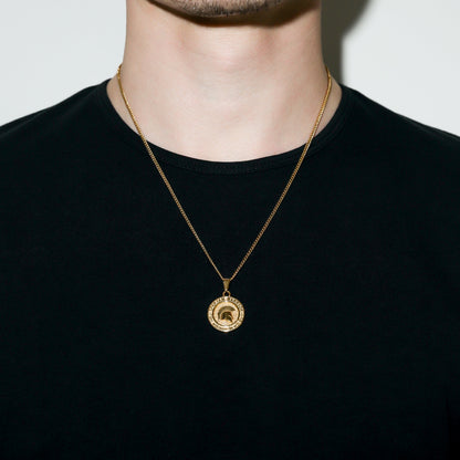 Gold Spartan warrior pendant necklace on neck with round medal-style charm.