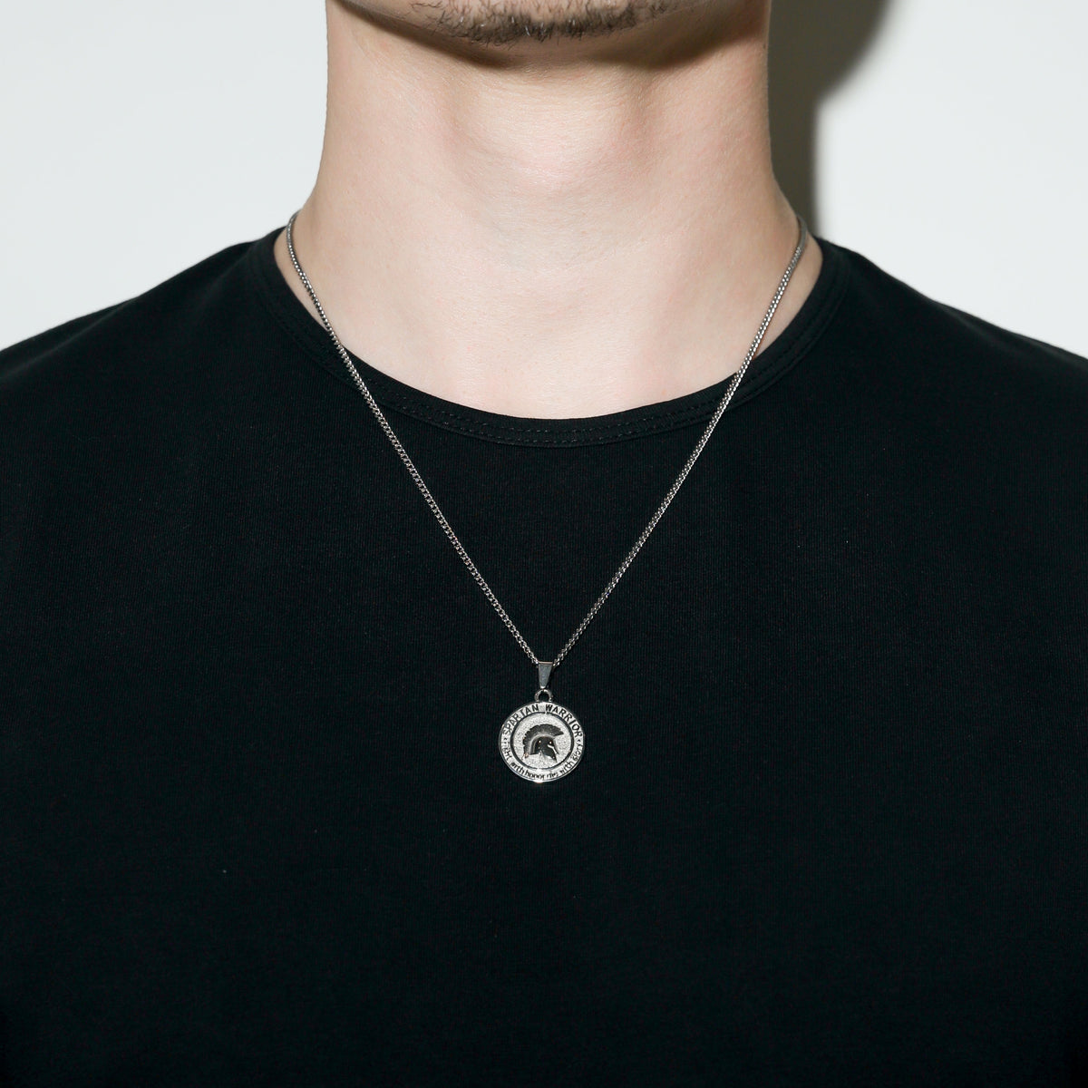Silver Spartan warrior pendant necklace with round coin pendant and cable chain.