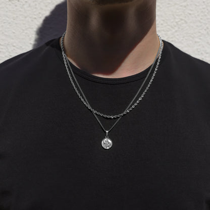 Two-layer silver rope necklace set with round Saint Christopher pendant on chest