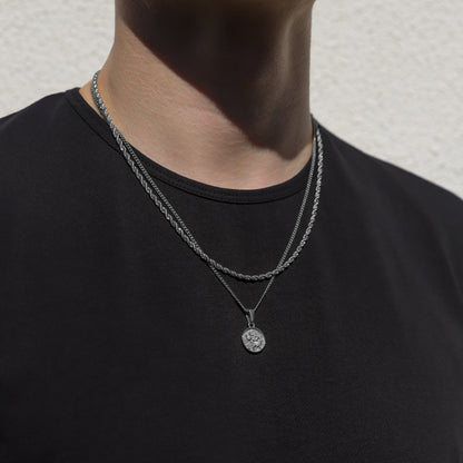 Silver rope necklace set with round Saint Christopher medallion pendant, worn on neck