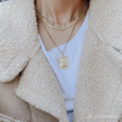 Gold crescent moon necklace with star charms and square pendant at the center