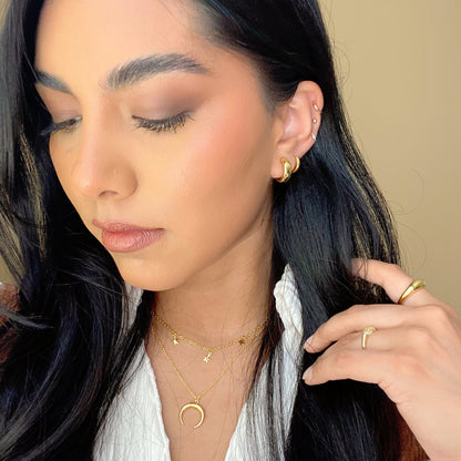 Gold layered star choker and crescent moon necklace worn close to the neck