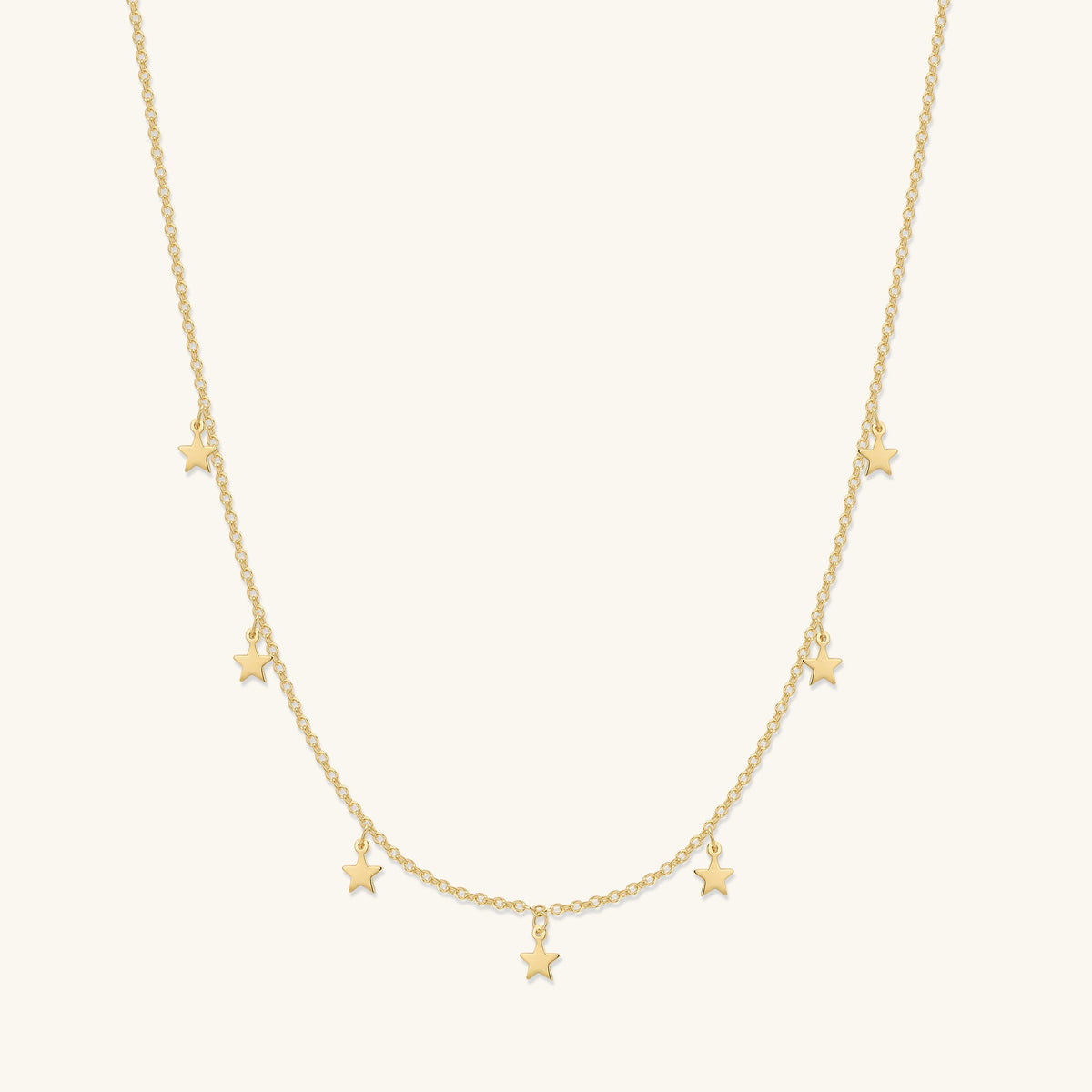Gold crescent moon and star necklace with small star charms along the chain
