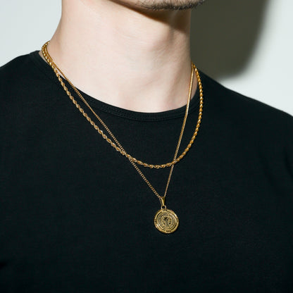 Gold Saint Benedict medal necklace close-up with round medal pendant on chest