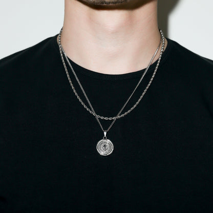 Silver Saint Benedict medal necklace with round medallion on a chain collar