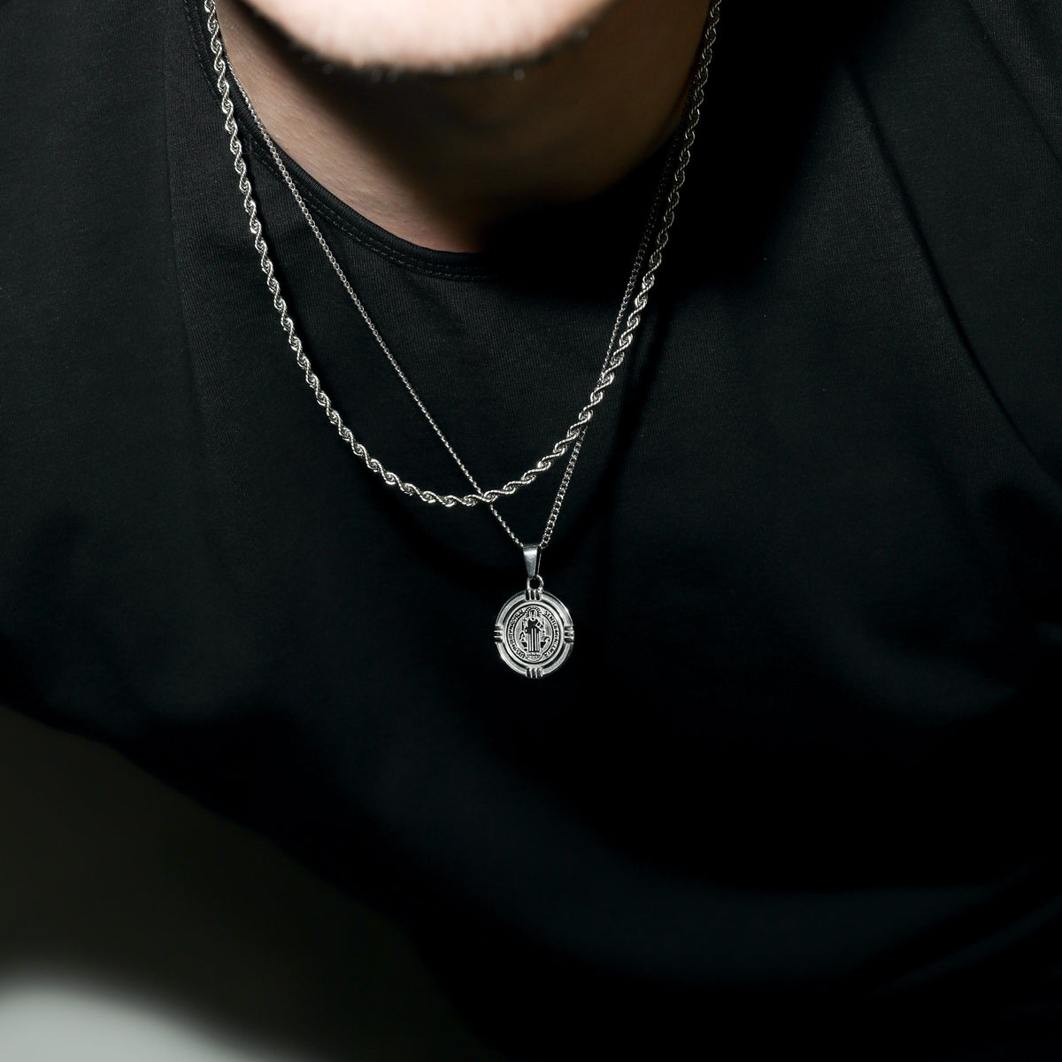Silver Saint Benedict medal necklace with circular medallion pendant on chain
