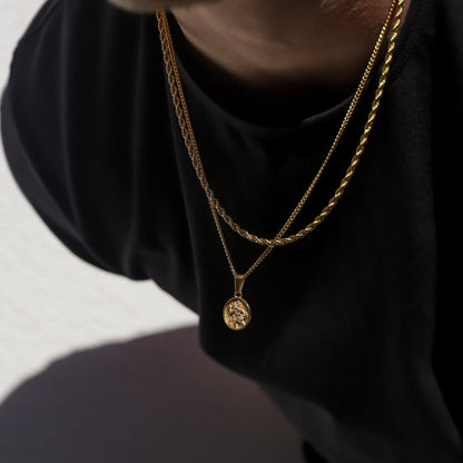 Close-up: gold double rope necklaces with Saint Christopher pendant charms