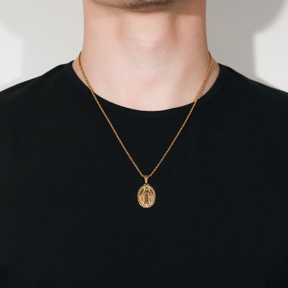 Gold Saint Mary pendant necklace on person, oval charm centered