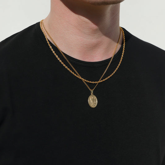 Gold rope chain necklace with round Saint Michael coin pendant hanging at center