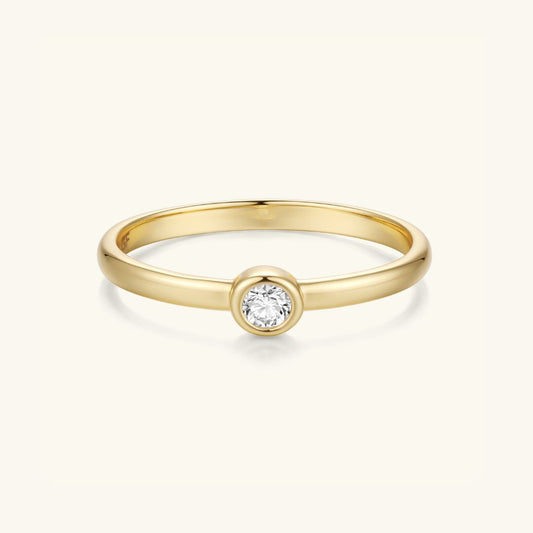 Gold bezel-set round stone ring with slim band and polished finish