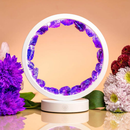 Amethyst healing lamp with glowing purple crystal ring and white base