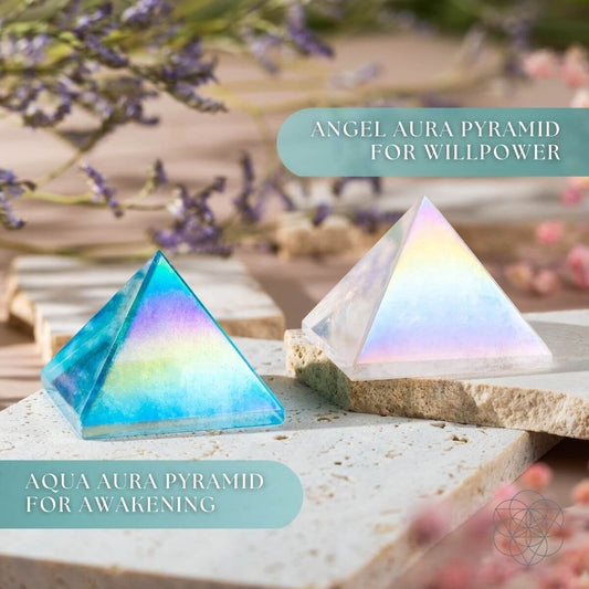 Two iridescent crystal pyramids, one blue teal and one rainbow white, on a stone base