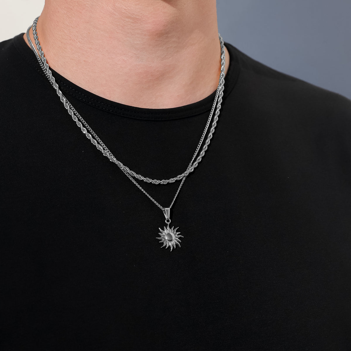 Sun pendant necklace with fine chain and sun charm at center