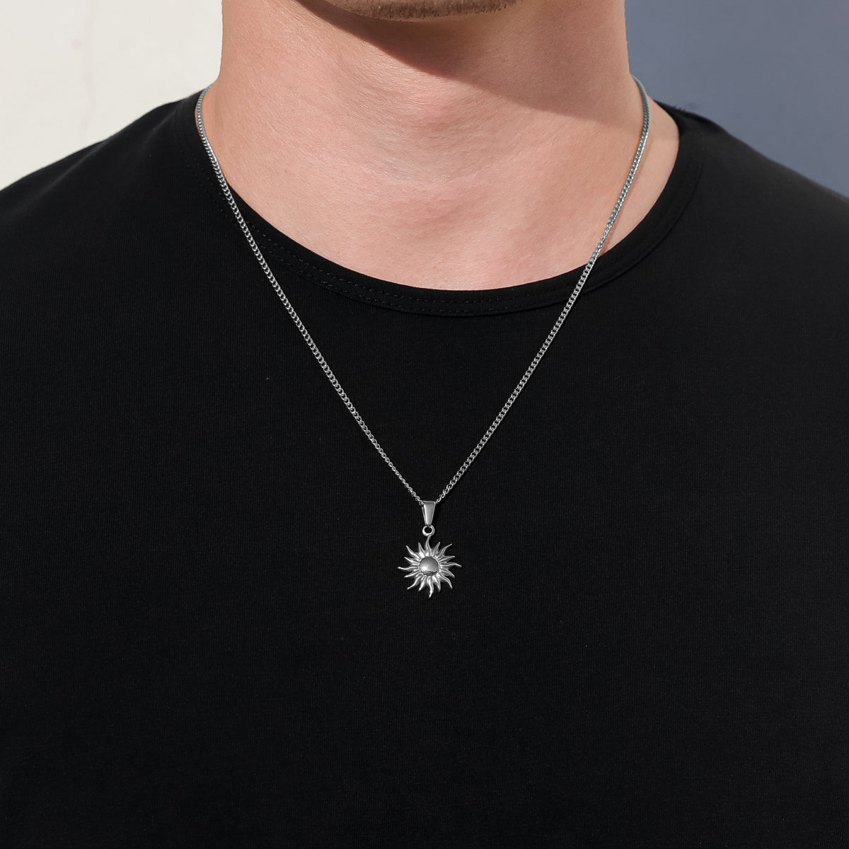 Sun pendant necklace with fine chain and small sun-shaped charm