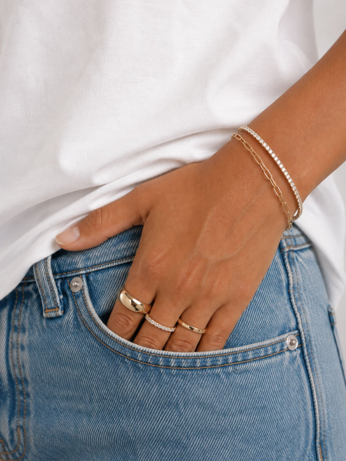 Gold paperclip chain bracelet on wrist with adjustable links and clasp
