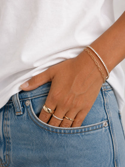 Gold paperclip chain bracelet on wrist with adjustable links and clasp
