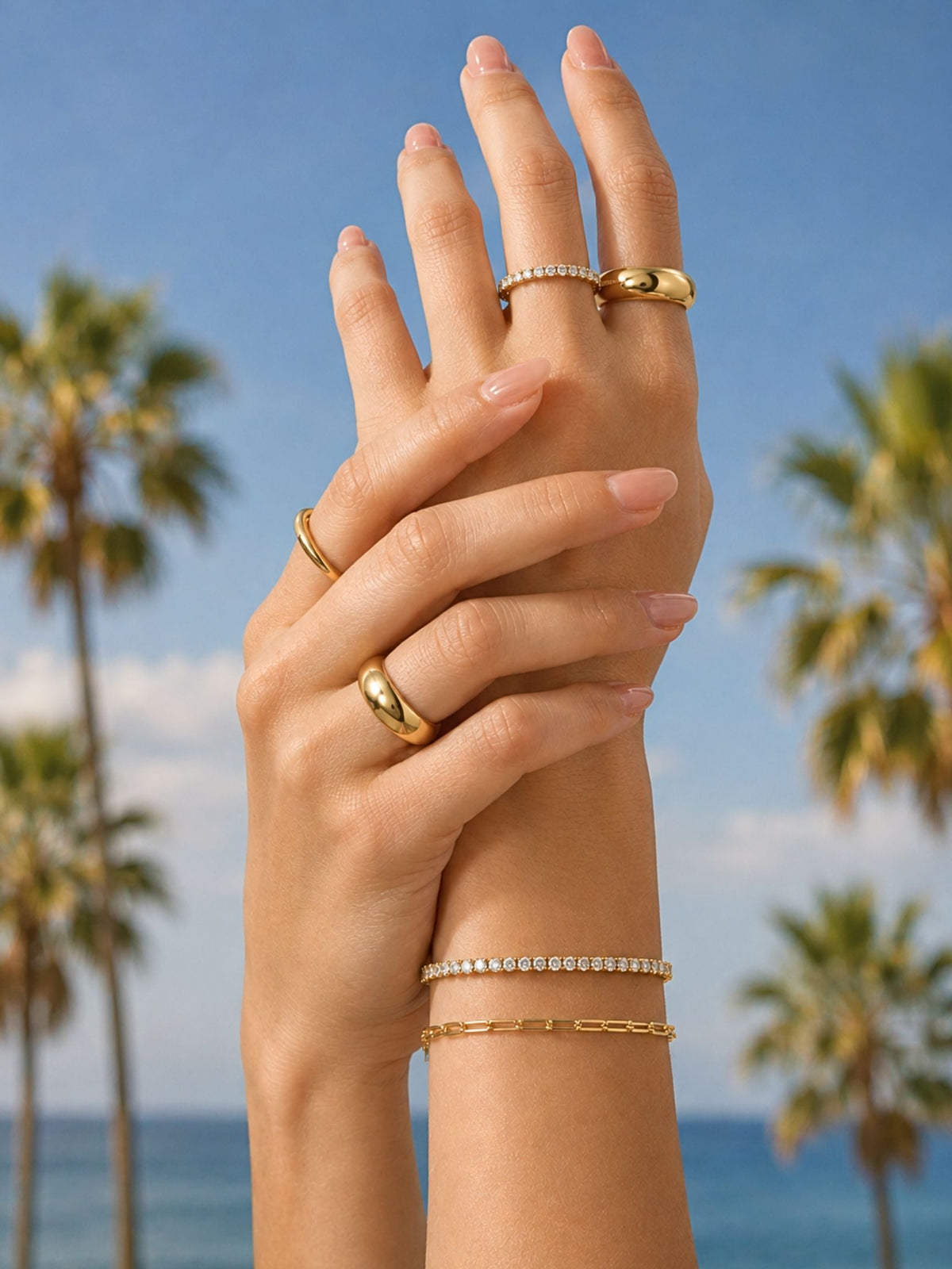 Gold paperclip chain bracelet worn on finger-and-wrist stack, adjustable length