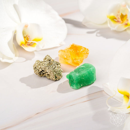 Raw crystal trio: green, orange-gold, and gold glitter mineral stones