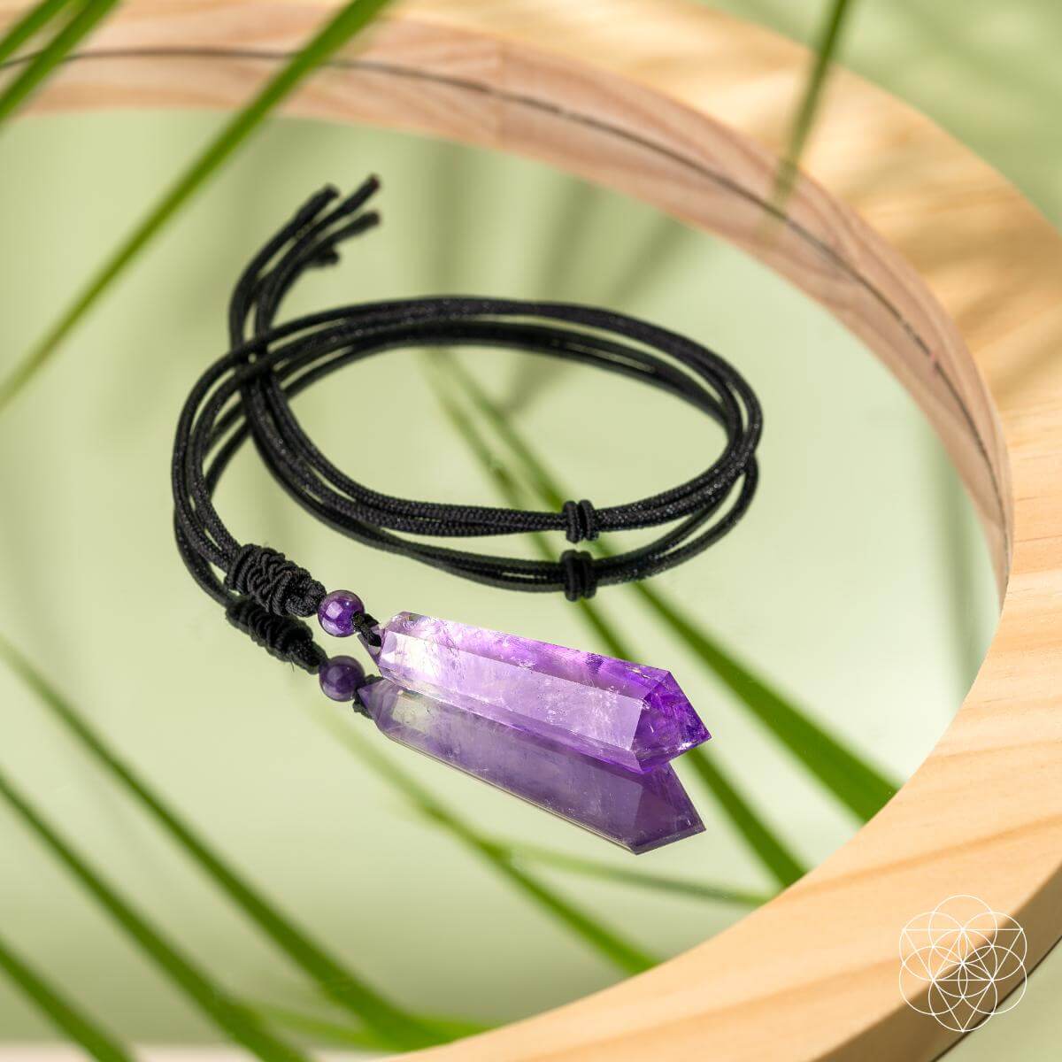 Amethyst point pendant necklace on black cord with purple bead, coiled
