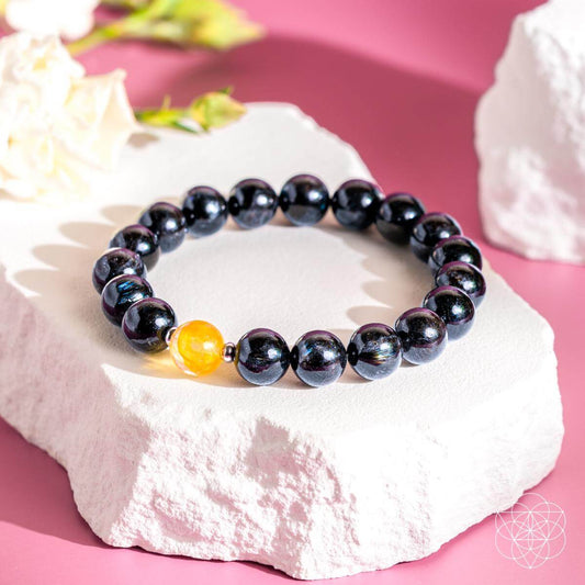 Arfvedsonite deep healing bracelet with dark beaded stones and one golden quartz bead