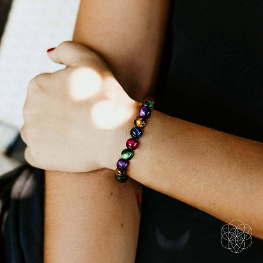 Beaded bracelet on wrist with multicolored round stone beads and elastic stretch fit