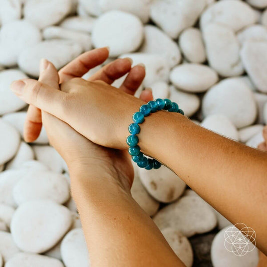 Teal blue beaded bracelet on wrist, round beads with elastic fit